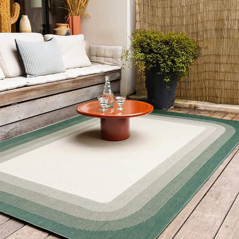 Tapis d’extérieur placé sous un salon de jardin sur une terrasse